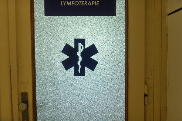 Door with medical symbol and lymphatic therapy sign in hospital
