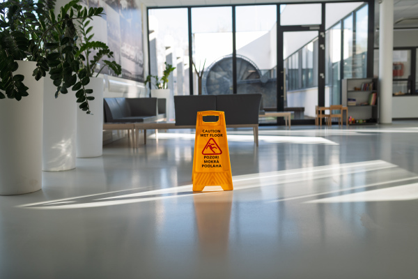 Wet floor warning sign in Slovak public building hallway