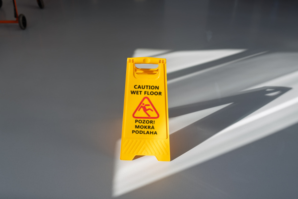 Wet floor warning sign in Slovak public building hallway