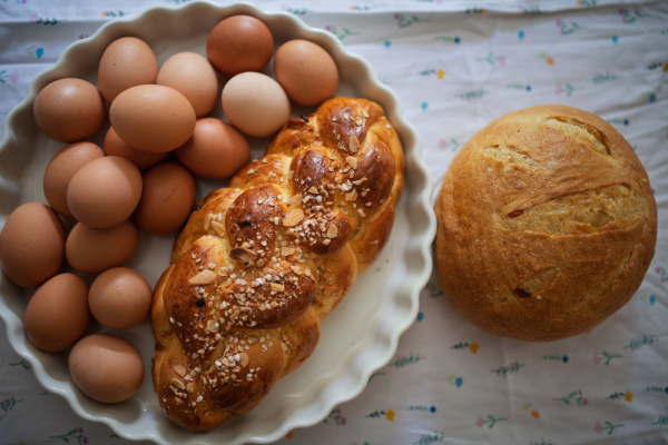 Homemade bread and eggs on rustic kitchen table. Traditional breakfast ingredients.