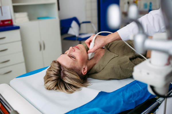 Female patient undergoing thyroid ultrasound examination. Lymp node sonography.