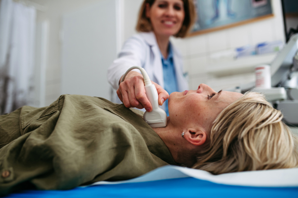 Female patient undergoing thyroid ultrasound examination. Lymp node sonography.