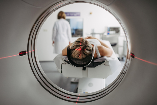 CT scanner view of patient during medical imaging procedure. Woman undergoing MRI scan.