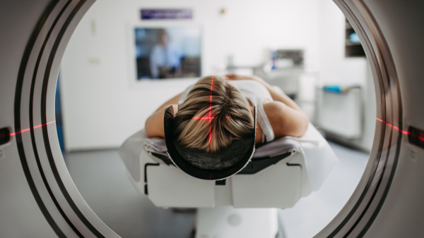 CT scanner view of patient during medical imaging procedure. Woman undergoing MRI scan.