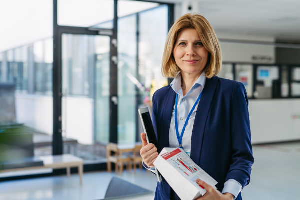 Portrait of female medical sales representative, medical clinic setting.