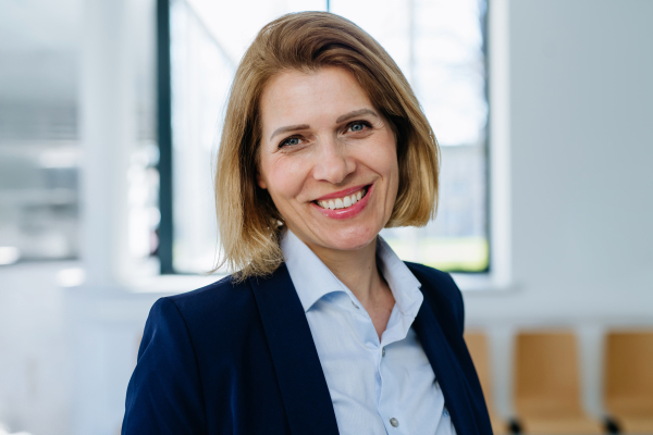 Portrait of female medical sales representative, medical clinic setting.