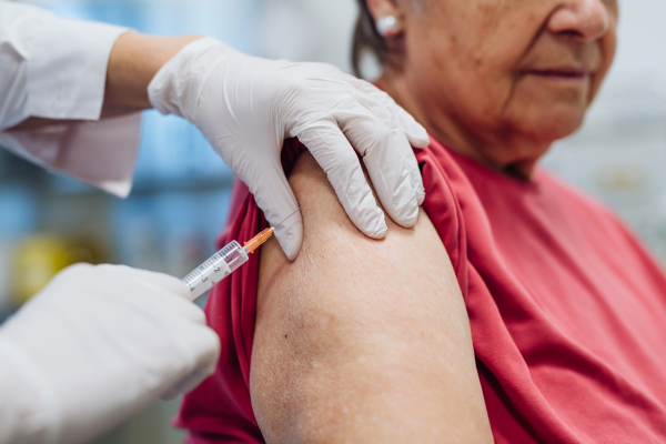 Elderly patient being vaccinated by doctor. Preventive care.