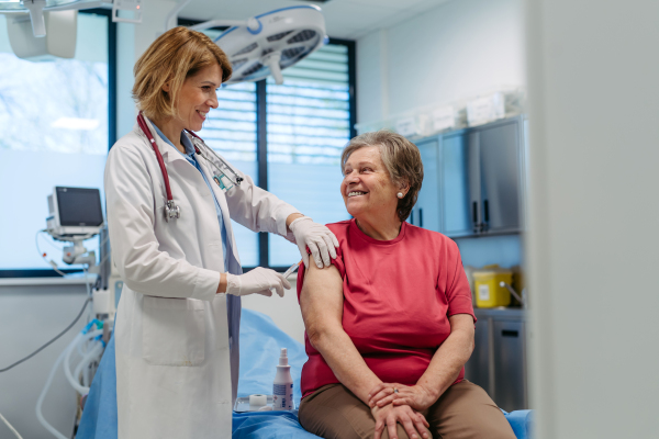 Elderly patient being vaccinated by doctor. Preventive care.