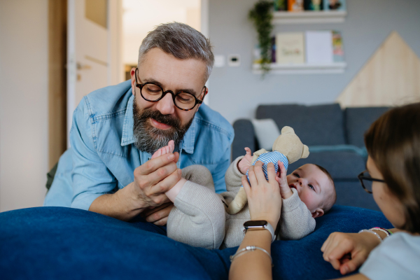 Older sister and father looking at newborn baby. Fathers day concept.
