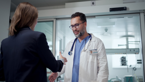 New manager introduces herself to the medical staff. Modern clinic, hospital setting.