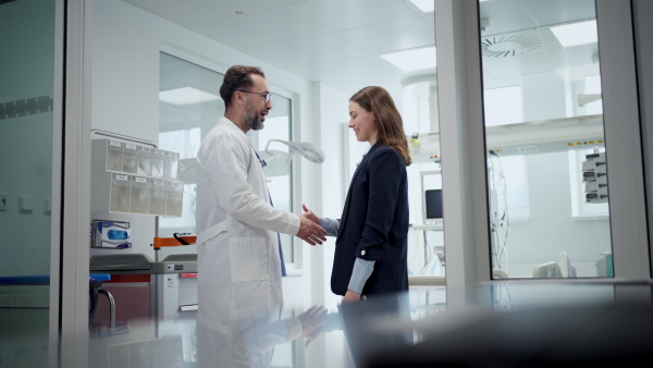 New manager introduces herself to the medical staff. Modern clinic, hospital setting.