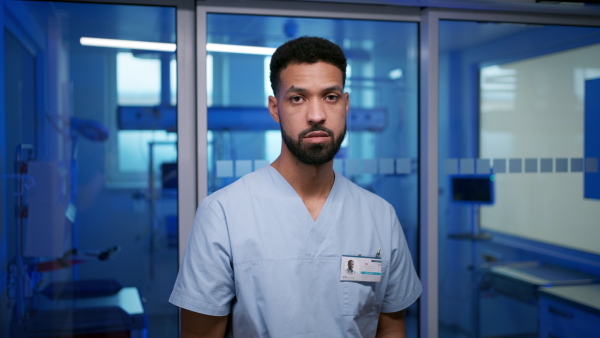 Serious young male nurse in hospital.