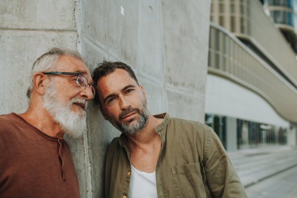 Generational family portrait of father and grown-up son. Fathers day concept.