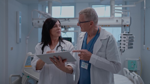 Two older doctors having a discussion about the results of the patient.
