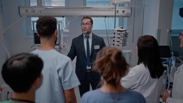 A pharmaceutical sales respresentative showing medical satff new medications. Group presentation in hospital setting.