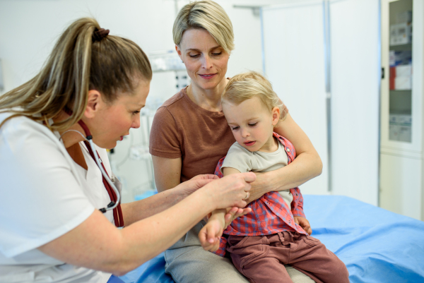 Doctor placing cotton and medical tape on the injection spot. Preventive care.