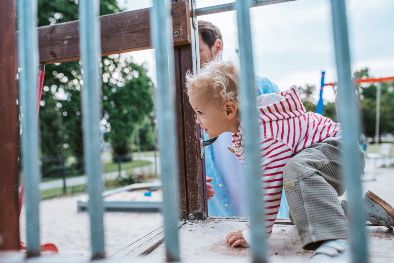 Portrait of dad and child enjoying time together on the playground. Fathers day concept.
