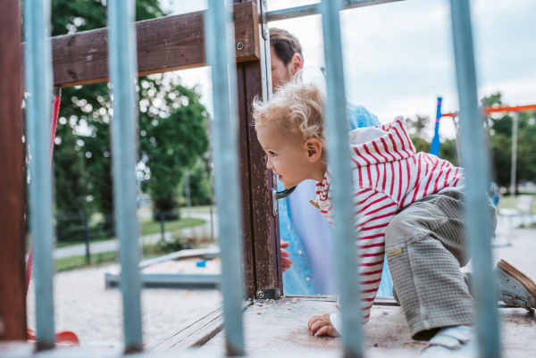 Portrait of dad and child enjoying time together on the playground. Fathers day concept.