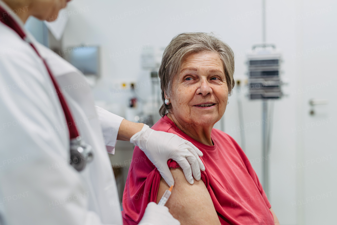Elderly patient being vaccinated by doctor. Preventive care.