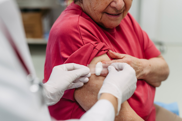 Elderly patient being vaccinated by doctor. Preventive care.