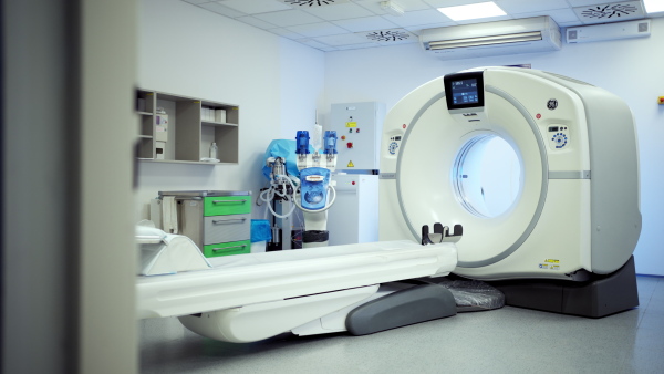 Modern CT scanner in empty radiology exam room. Hospital setting.