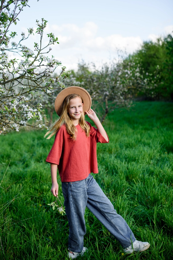 Girl enjoying spring blossoms in the garden.