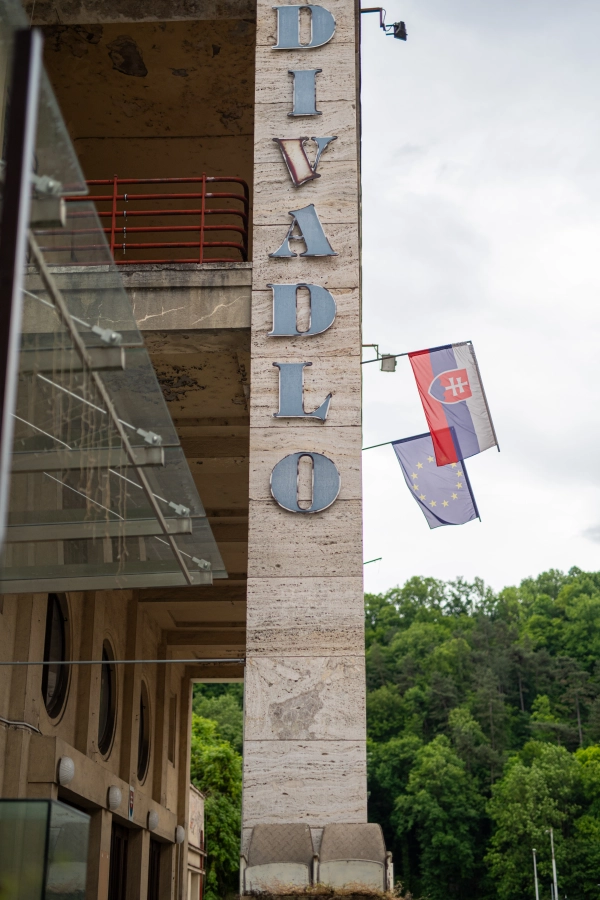 Facade of the State Opera House in Banska Bystrica with Slovak and EU flags