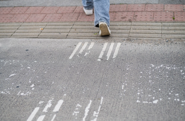 Pedestrian crosswalk with walking citizen.