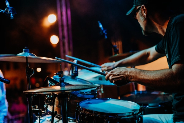 Live drum performance at night concert.
